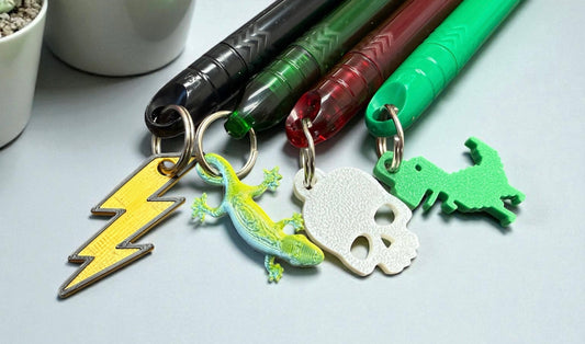 Collection of mini pens that have cute keychain charms attached
