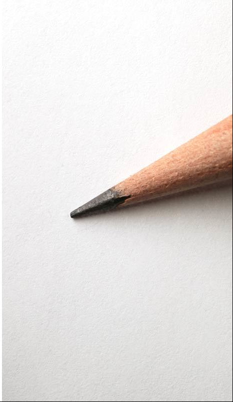 Three views of a sharpened pencil on a white background