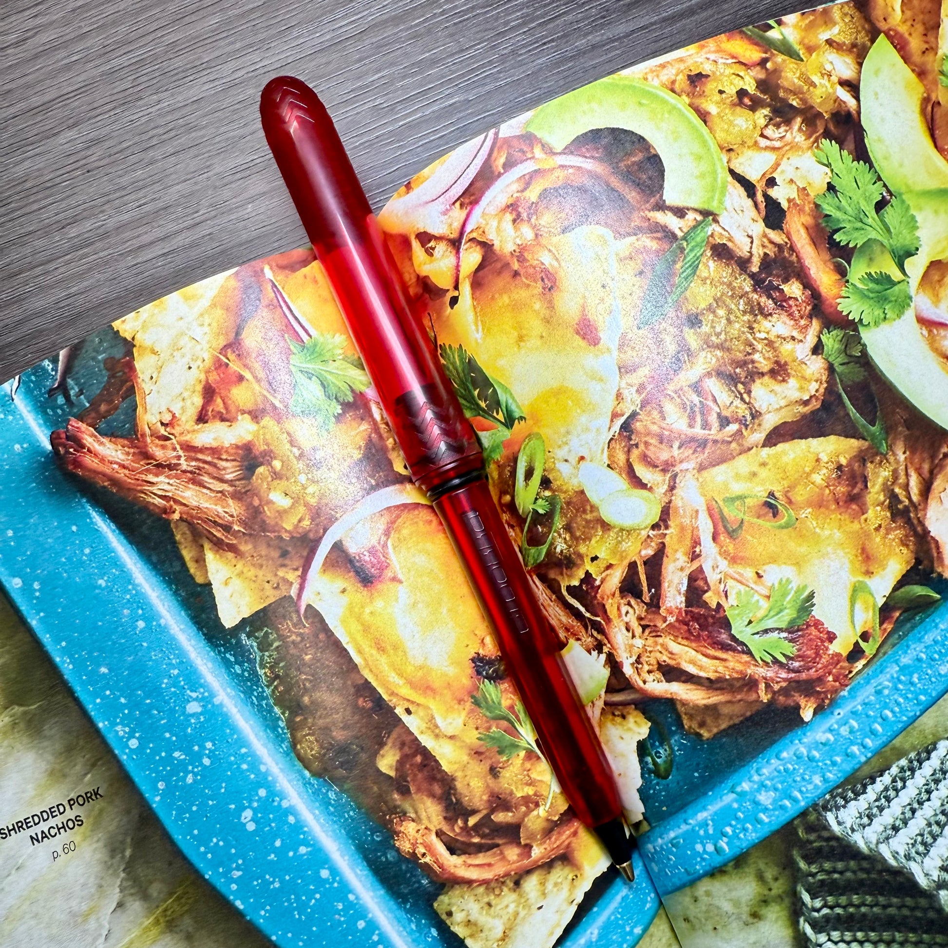 Red pen on a tray with a food-themed design
