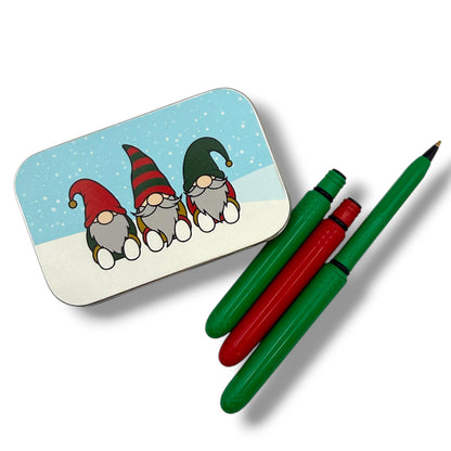 Tin with cartoon gnomes and two pens on a white background