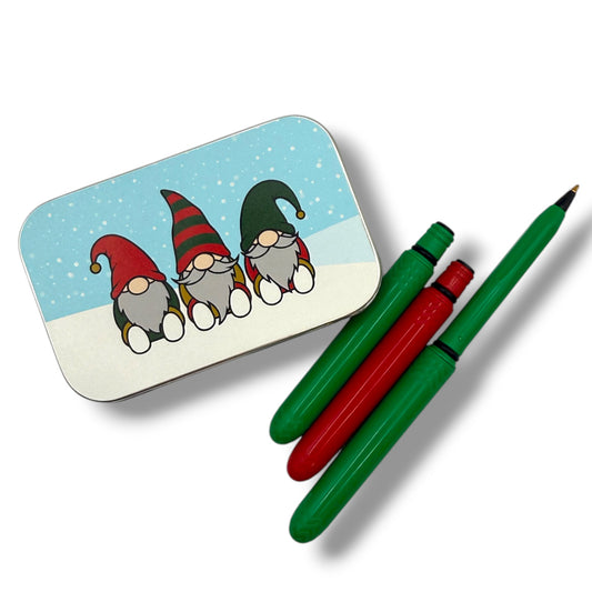 Tin with cartoon gnomes and two pens on a white background