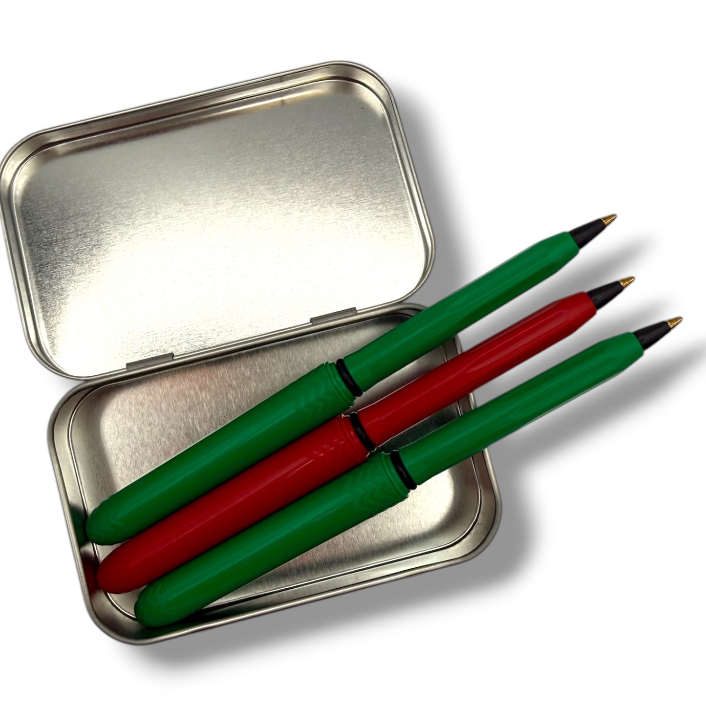 Three green and red pens in a metal case on a white background