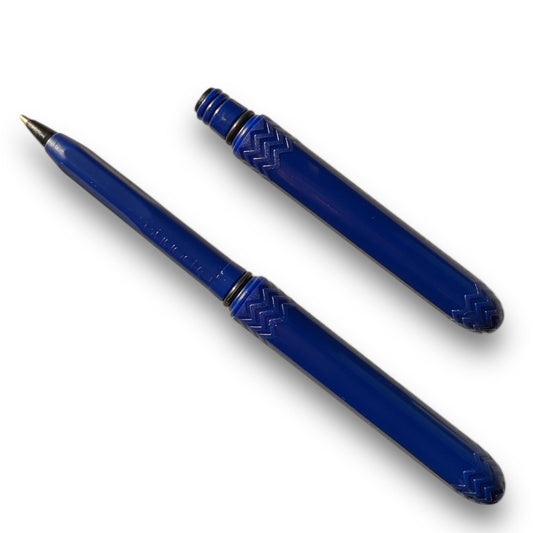 A blue ballpoint pen with its cap removed, showing the tip and the blue barrel with patterned detailing.